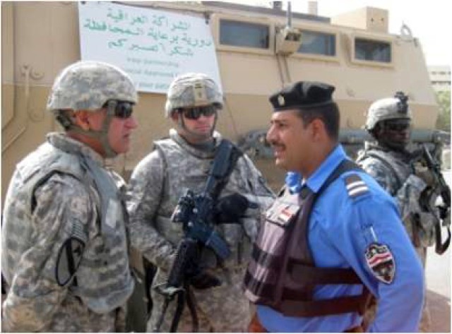 U.S. Soldiers from 3rd battalion, 82nd Field Artillery Regiment, 2nd Brigade Combat Team, 1st Cavalry Division, meet with Iraqi Emergency Response Unit members and gather information during an ERU checkpoint inspection in Kirkuk, Iraq. The purpose...