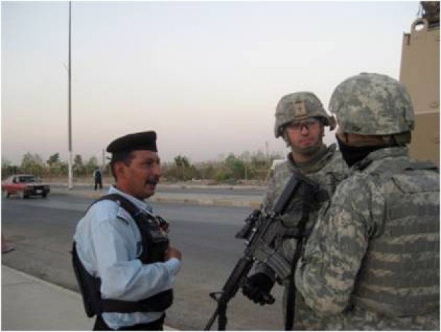 U.S. Soldiers from 3rd battalion, 82nd Field Artillery Regiment, 2nd brigade Combat Team, 1st Cavalry Division, meet with Iraqi Emergency Response Unit members and gather information during an ERU checkpoint inspection in Kirkuk, Iraq. The purpose...