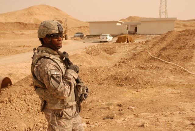Sgt. 1st Class Mark Haliburton, a Midway, Ala., native and a military police platoon leader with 2nd Special Troops Battalion, 2nd Brigade Combat Team, 1st Cavalry Division, stands in front of the new school being constructed in Chemin, Iraq, during ...