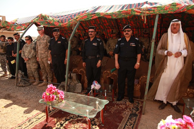 Soldiers, Iraqi policemen and local leaders stand together to celebrate the validation of Hawijah Police Station 3 in Hawijah, Iraq, Sept. 3. Officers at this station will work closely with their U.S. counterparts in the future to help keep the...