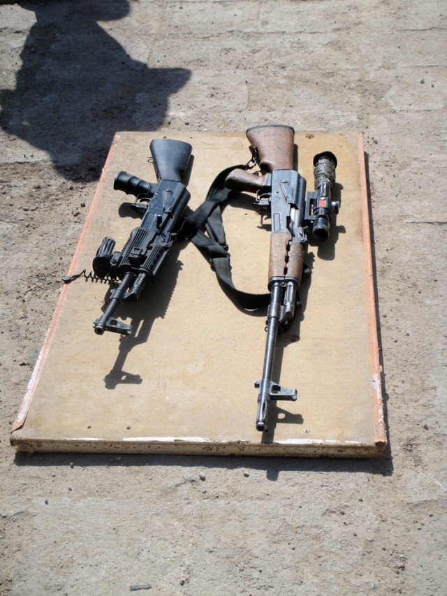 A Dragunov sniper rifle (right) and an AK-47 assault rifle are displayed during a long range marksmanship course provided by Soldiers from 4th Squadron, 9th Cavalry Regiment, 2nd Brigade Combat Team, 1st Cavalry Division, for Iraqi Army soldiers...