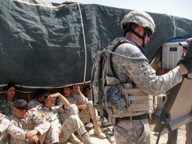 Sgt. Alan Frink, from Greenfield, Mass., and a marksmanship instructor with 4th Squadron, 9th Cavalry Regiment, 2nd Brigade Combat Team, 1st Cavalry Division, teaches Iraqi Army soldiers from the 15th IA Brigade on firing techniques, near Kirkuk...