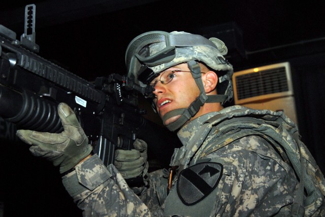 CAMP LIBERTY, Iraq -Sgt. John Liter, of Lexington, Ky., targets insurgents on the video screen at the Engagement Skills Trainer at Camp Liberty, here, Sept. 25. Liter, a cavalry scout assigned to Company A, Division Special Troops Battalion, 1st...