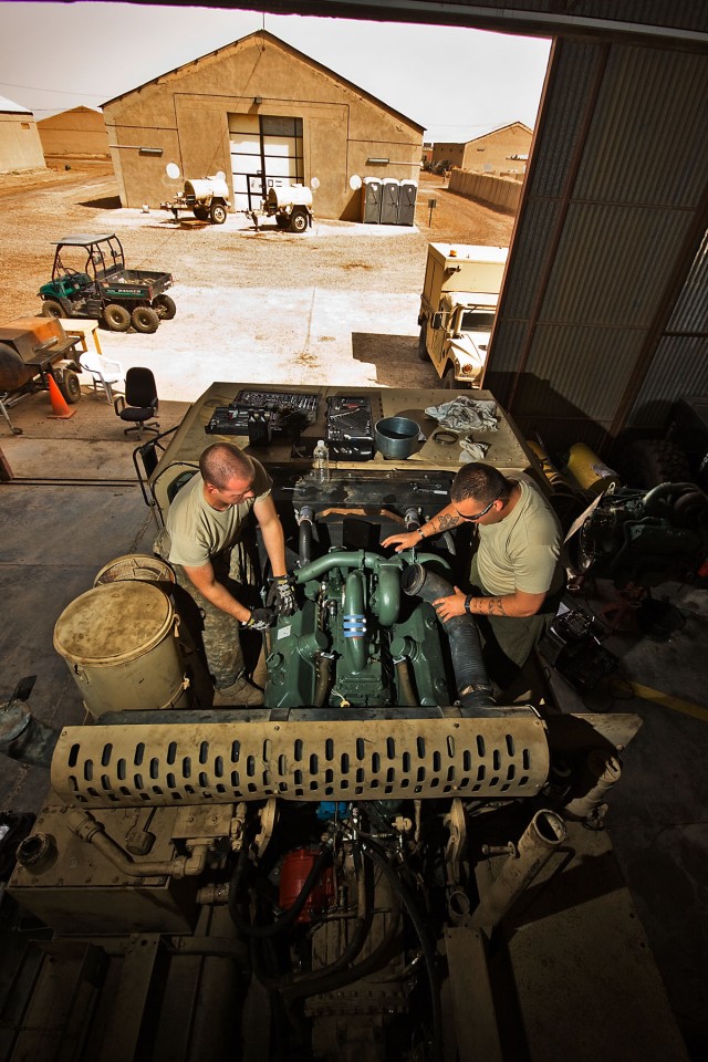 CAMP TAJI, Iraq-Before removing an engine from a fuel truck, Spc. Austin Hunt (left), from Odessa, Texas, and Spc. Paul Aragon (right), from El Paso, Texas,  both light wheeled mechanics in Company E, 4th Battalion, 227th Aviation Regiment, 1st Air C...