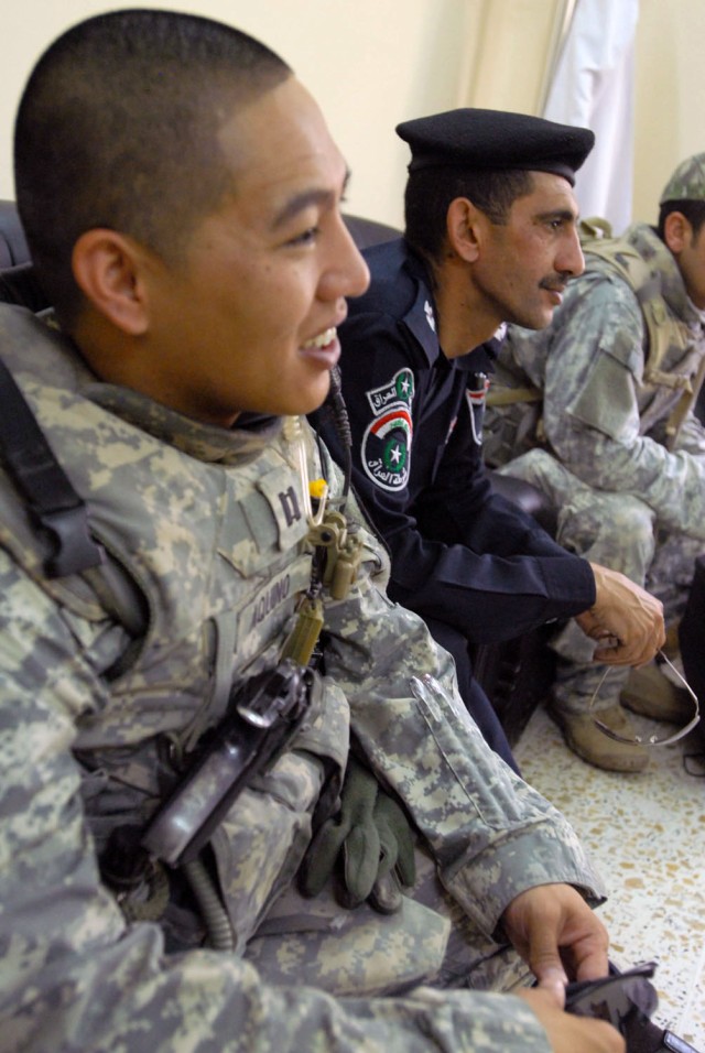 TAJI, Iraq- Little Rock, Ark. Native, Capt. Alex Aquino, commander of Battery B, 1st Battalion, 82nd Field Artillery Regiment, and Hamamiyat Federal Police Station commander, Maj. Thamir, listen as the clinic manager explains the changes the...