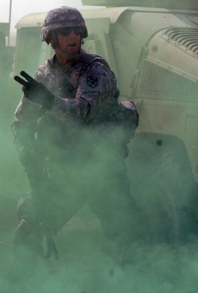 2nd Lt. Samuel Campbell, 15th Sustainment Brigade Personal Security Detachment platoon leader and Austin, Texas, native, gives orders to his Soldiers while under a simulated attacked during training here, Sept. 18. (U.S. Army photo by Sgt. Matthew...