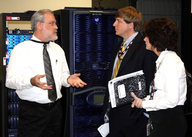 Charlie Wilcox, USASMDC/ARSTRAT Simulation Center program manager, left, talks with Ben Matthews, project manager, and Cathy Hatchett, security manager, both with GaN Corporation. GaN Corporation was recently awarded an 8(a) Competitive Set-Aside con...