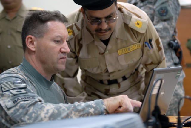 BAGHDAD - Omaha, Neb. native, Lt. Col. Daniel Barnes (left), an MND-B medical operations officer, shares information prior to the start of a medical lecture with Iraqi Army Maj. Qaisar Abdul al-Shami (right), a rheumatologist, during a joint medical ...