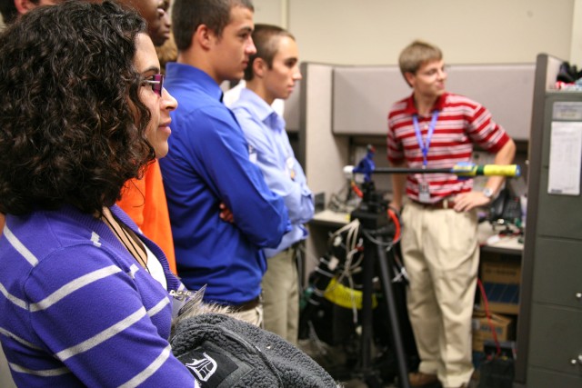 Gretchel Fernandez, of Columbia High School, and other students look on as the Technical Center prepares to demonstrate their "live fire" tracking and firing system. The system was put together by college students and is made primarily of common...