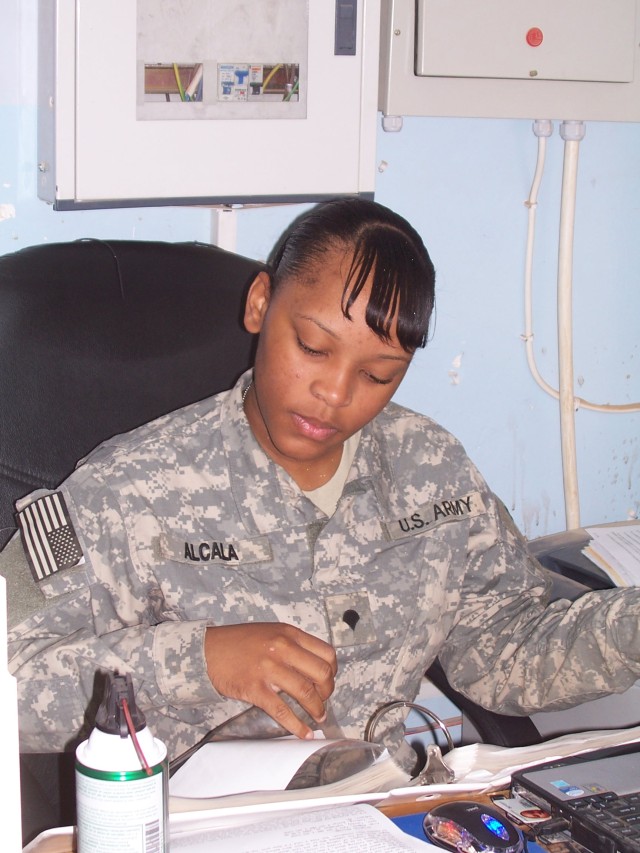 Spc. Anika Alcala, a supply specialist with the 395th Combat Sustainment Support Battalion, reads at her desk in the supply office.  Alcala, from Brooklyn, N.Y., is pursuing a degree in criminal justice through an online university. (U.S. Army photo ...