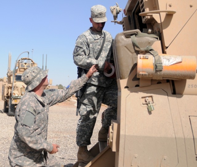 Pfc. Todd Whelehan, personal security detachment ,15th Sustainment Brigade and Palm Bay Fla. Native fills in Sgt. Hagstrom, a San Bernadino, Calif. Native about the maintenance the team is performing on the Mine-Resistant-Ambush-Protected vehicle....