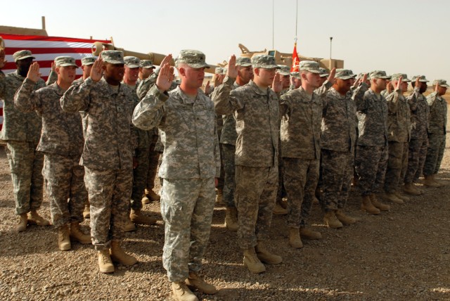 CAMP TAJI, Iraq - Forty-one Soldiers of the 1st Battalion, 82nd Field Artillery Regiment, 1st Brigade Combat Team, 1st Cavalry Division, raise their right hands during a re-enlistment ceremony held at Fire Base Mayhem here, Oct. 4. Lt. Col. Eric...