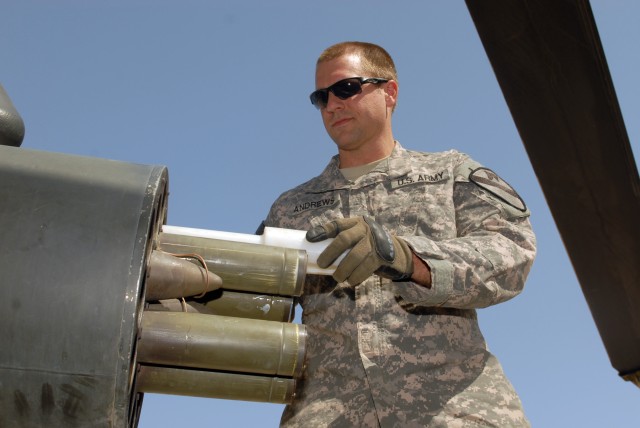 CAMP TAJI, Iraq - Sgt. Scott Andrews, of West Point, Miss., loads rockets into the rocket pod of an AH-64D Apache helicopter, here, Oct. 1. Gibson is an armament electrical avionics repairer assigned to Company D, 1st Battalion, 227th Aviation...