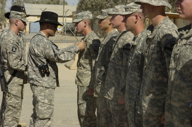 Col. Ryan Gonsalves, brigade commander of the 2nd "Black Jack" Brigade Combat Team, 1st Cavalry Division, pins Cpl. Adam Seiffert, a gunner for 1st Platoon, Blackhawk Troop, 4th Squadron, 9th Cavalry Regiment, with the Purple Heart medal. The...