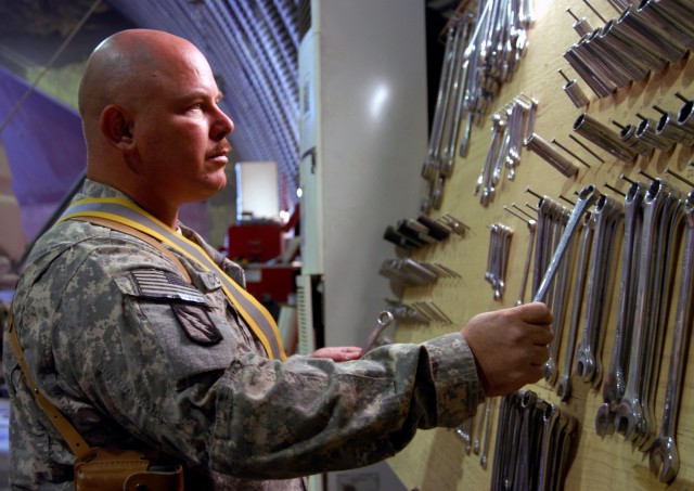 Sgt. 1st Class Wilton R. Cooper, motor sergeant for C Company, 2nd Battalion, 198th Combined Arms, Mississippi Army National Guard, out of Oxford, Miss., selects a handful of wrenches while assisting with vehicle maintenance Sept. 30. Diligent...