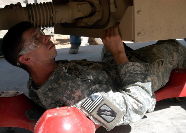 Spc. Robert J. Algee, a mechanic from Senatobia, Miss., checks for leaks and other deficiencies during a quality assurance and quality check of an MRAP Sept. 30.  Algee serves with B Company, 2nd Battalion, 198th Combined Arms out of Greenwood,...