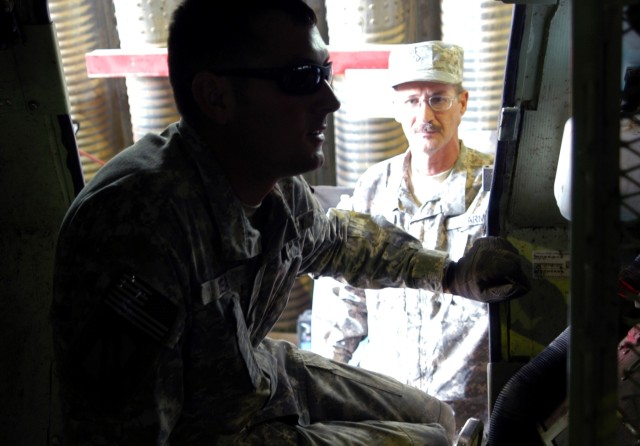 Spc. Jason E. Dean (left), a mechanic from Brooklyn, Miss., and Pfc. Joseph V. Morgan, a mechanic from Seminary, Miss., inspect the interior of an M1117 Armored Security Vehicle Sept. 30, after the ASV suffered a rollover during a mission. Both...