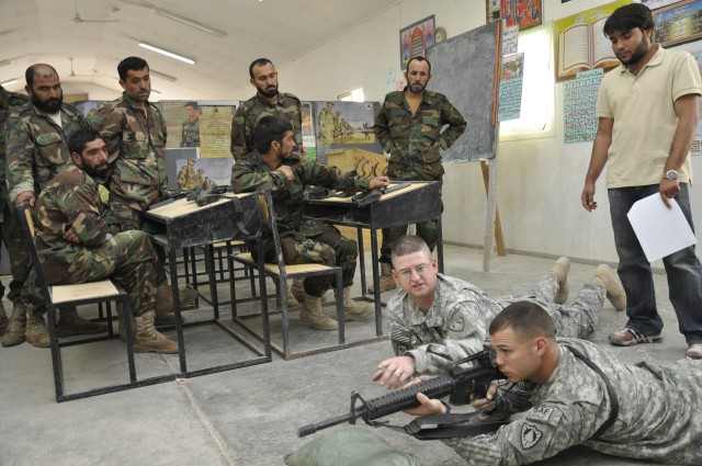 KANDAHAR AIRFIELD, Afghanistan - Capt. Jeff Whitten, the 286th Combat Support Sustainment Battalion headquarters and headquarters company commander, explains while Staff Sgt. Kyle Roy, a 286th CSSB HHC operations noncommissioned officer, demonstrates...
