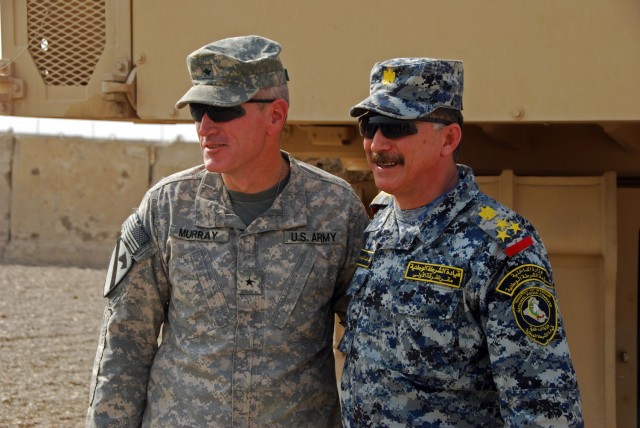 CAMP TAJI, Iraq- Kenton, Ohio native, Brig. Gen. John Murray (left), deputy commanding general of maneuver for the 1st Cavalry Division, poses for a picture alongside Gen. Ayad, the chief of staff for the Rusafa area command during a visit to Firebas...