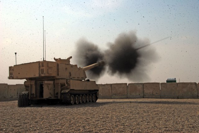 CAMP TAJI, Iraq- Smoke and dust rise as an M109A6 155mm howitzer assigned to 1st Battalion, 82nd Field Artillery, 1st Brigade Combat Team, 1st Cavalry Division, fires during a visit from Brig. Gen. John Murray, the deputy commanding general for maneu...