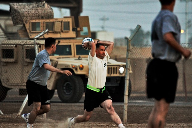 CAMP TAJI, Iraq-Maj. Marcus Gengler (center), from Ontario, Calif., commander, Company B, 615th Aviation Support Battalion, takes a throw in during a scrimmage game, Oct 10. Gengler and his team were defeated 5-4 by 4th Battalion, 227th Aviation...
