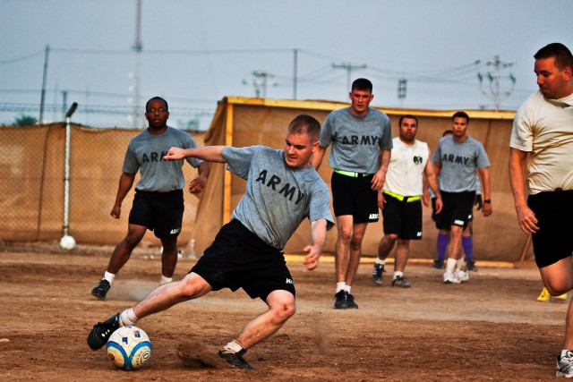 CAMP TAJI, Iraq-Players from the 615th Aviation Support Battalion and 4th Battalion, 227th Aviation Regiment, both of the 1st Air Cavalry Brigade, look on, during a scrimmage game between the two battalions, Oct.10, at Camp Taji, Iraq. The game...