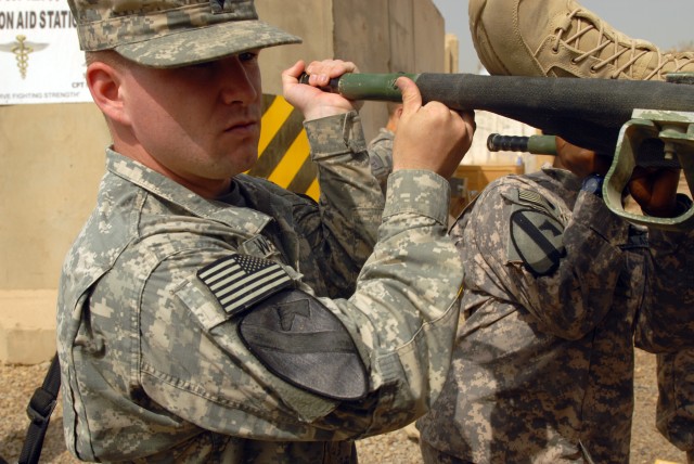 CAMP LIBERTY - Spc. Murphy Wakefield, of St. Albans, Vt., (left) and Pfc. Kamella Givans, of West Palm Beach, Fla., load a litter onto an ambulance outside the Division Special Troops Battalion aid station, here, Oct. 9. Both Soldiers are assigned to...