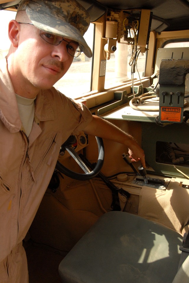 BAGHDAD- Sgt. Abraham Kay, a motor pool maintenance squad leader, from Coleman, Texas, points out the transfer case lever inside a humvee, here, Oct. 12.  The transfer case lever sits between the brake and transmission gearshift.  In a humvee,...