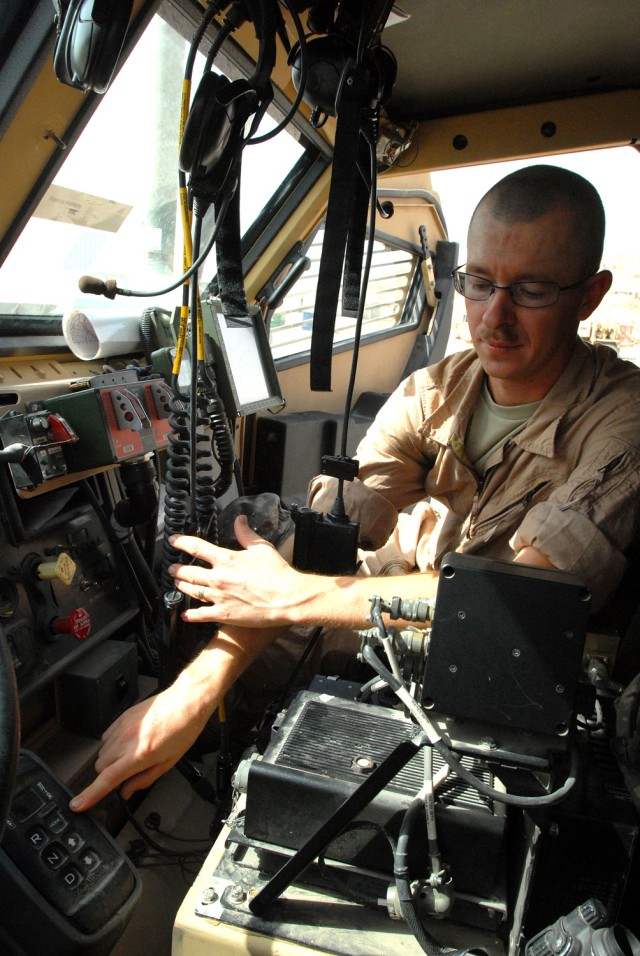 BAGHDAD- Sgt. Abraham Kay, a motor pool maintenance squad leader, from Coleman, Texas, points to the mode panel on the transmission control module inside a Mine-Resistant Ambush-Protected vehicle, here, Oct. 12.  A lower gear ratio gives more...