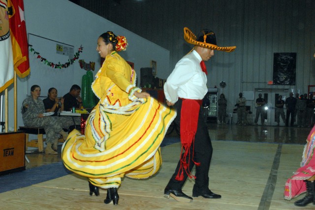 CAMP LIBERTY, Iraq - Staff Sgt. Alma Selvera (left), of Oklahoma City, Okla., and Sgt. 1st Class Frank Rodriguez, of San Marcos, Texas, perform a traditional Jalisco Mexican dance as part of the group "Raices Mexicanas" at the Multi-National Division...