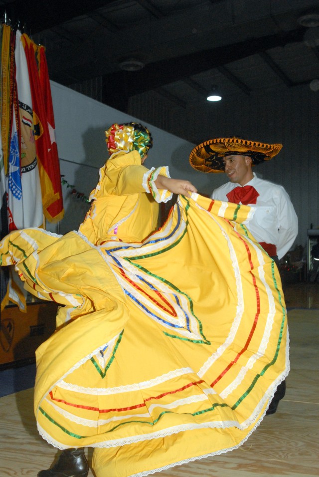 CAMP LIBERTY - Staff Sgt. Alma Selvera (left), of Oklahoma City, Oklahoma, and Sgt. 1st Class Frank Rodriguez, of San Marcos, Texas, perform a traditional Jalisco Mexican dance as part of the group "Raices Mexicanas" at the Multi-National Division-Ba...