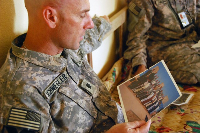 TAJI, Iraq- Ozark, Ala. native, Lt. Col. Eric Schwegler, commander of the 1st Battalion, 82nd Field Artillery Regiment, 1st Brigade Combat Team, 1st Cavalry Division, views a picture of Sheik Abdullah and his Sons of Iraq comrades during a visit,...