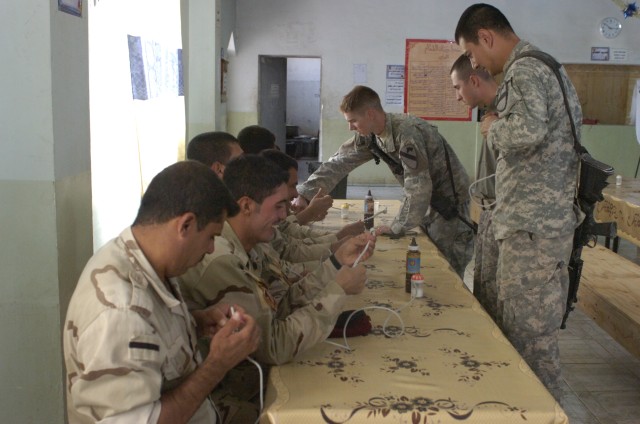 Soldiers from Echo Company, 1st Battalion, 8th Cavalry Regiment, train Iraqi Army soldiers during the classroom portion of a training course held on Forward Operating Base Warrior, Kirkuk, Iraq, Oct. 6. The class introduced military demolitions...