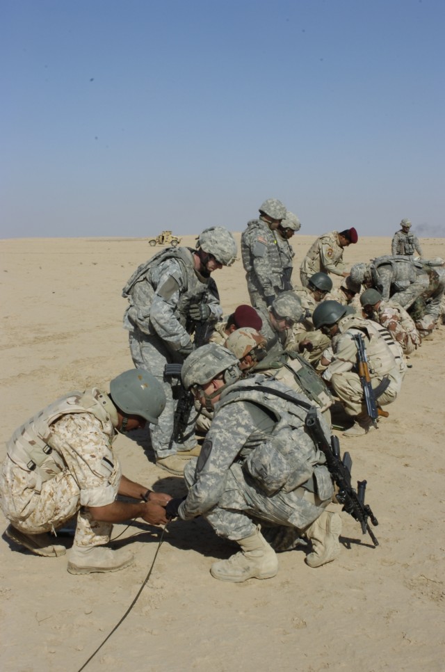 U.S. and Iraqi Army Soldiers set up a live demolition range as the last part of a training course led by Soldiers from Echo Company, 1st Battalion, 8th Cavalry Regiment, held on Forward Operating Base Warrior, Kirkuk, Iraq, Oct. 6. The class...