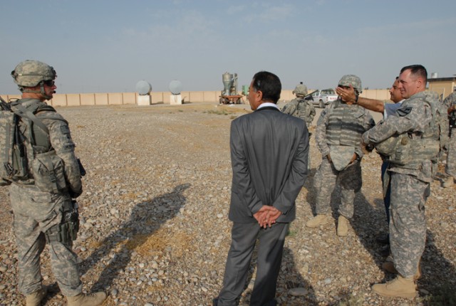 Ghazi al-Deen Talabani (hand up) shows Lt. Col. Hugh McNeely (right), the deputy commanding officer of 2nd Brigade Combat Team, 1st Cavalry Division, where a new micro-dairy farm will be located during a visit, Oct. 8. This micro-dairy farm will...