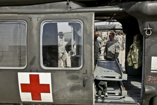 CAMP TAJI, Iraq-During a visit to Camp Taji, Iraq, Oct. 13, Sgt. John Hyland (in doorway), who lost his leg during combat operations on a previous deployment to Iraq, recounts his story to medevac Soldiers from 2nd Battalion, 227th Aviation...