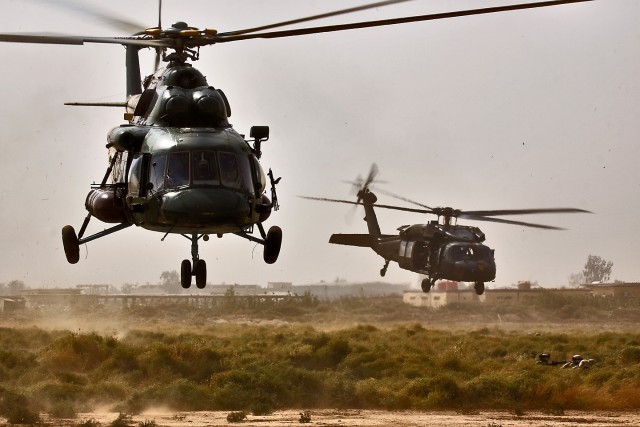 CAMP TAJI, Iraq-An MI-17 Hip helicopter (left) from the Iraqi Air Force and a UH-60 Black Hawk helicopter from 3rd Battalion, 227th Aviation Regiment, 1st Air Cavalry Brigade, 1st Cavalry Division, drop off Soldiers from the  34th Iraqi Army Brigade,...