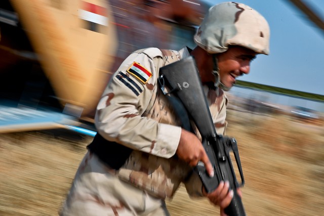 CAMP TAJI, Iraq-Almost all is a blur as am Iraqi Soldier from the 34th Brigade, 9th Iraqi Division, charges out the back of an MI-17 Hip helicopter during a joint air assault training mission between the Iraqi Air Force, the Iraqi Army and the 1st...