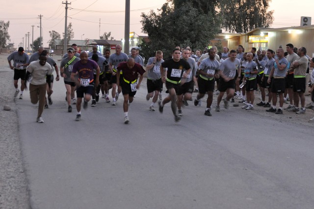 CONTINGENCY OPERATING LOCATION Q-WEST, Iraq - The first group of runners take off on the first leg of the 10-Mile Relay here Oct. 17. The 10-mile run was broken up into three 3.3-mile laps, and each member of a three-person team ran one lap. (U.S. Ar...