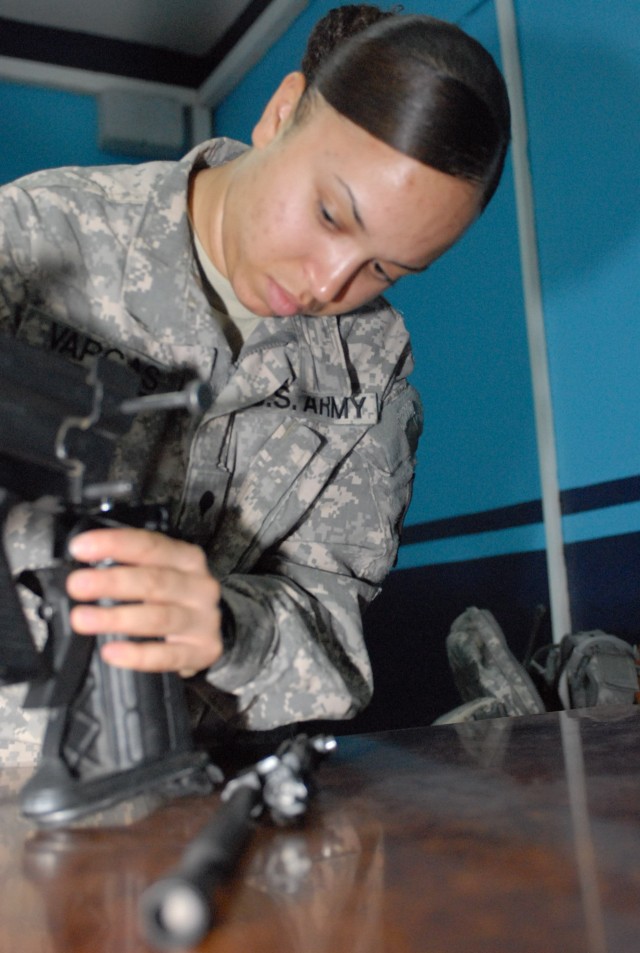 Spc. Stephanie Vargas, an operations clerk with the 506th Quartermaster Company out of Fort Lee, Va., and a Manhattan, N.Y., native, practices disassembling the M249 Squad Automatic Weapon in preparation for the brigade Soldier of the quarter...