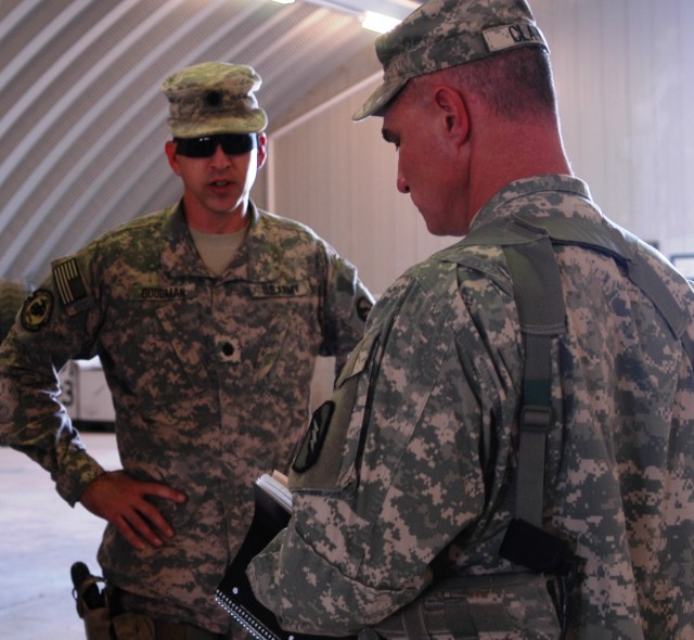 CONTINGENCY OPERATING LOCATION Q-WEST, Iraq - Lt. Col. Kerry Goodman (left) of Meridian, Miss., discusses results of an Oct. 11 excess inventory inspection with Capt. Drew Clark of Madison, Miss., who prepares to take notes. Goodman commands 2nd...