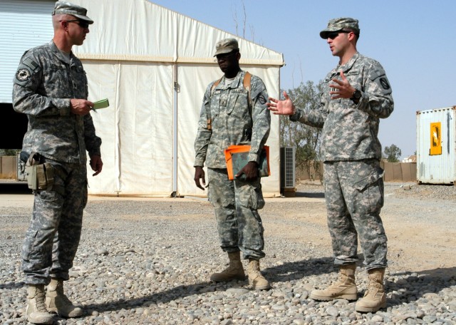 CONTINGENCY OPERATING LOCATION Q-WEST, Iraq - Lt. Col. Kerry Goodman (left), a native of Meridian, Miss., and commander 2nd Battalion, 198th Combined Arms headquartered in Senatobia, Miss., listens to a brief by 1st Lt.  Jesse Hill, Jr. (middle),...