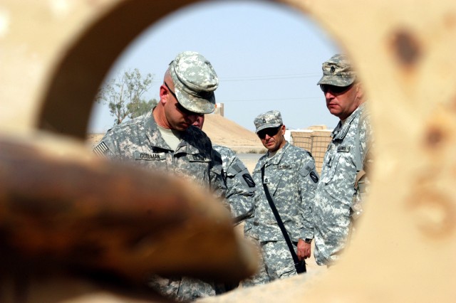 CONTINGENCY OPERATING LOCATION Q-WEST, Iraq - Seen through the tow ring of an Armored Security Vehicle, Lt. Col. Kerry Goodman (left), a native of Meridian, Miss., and commander 2nd Battalion 198th Combined Arms headquartered in Senatobia, Miss.,...