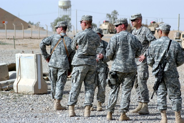 CONTINGENCY OPERATING LOCATION Q-WEST, Iraq - Lt. Col. Kerry Goodman (second from right), commander of 2nd Battalion, 198th Combined Arms headquartered in Senatobia, Miss., stands surrounded by battalion staff and company leaders during an excess...