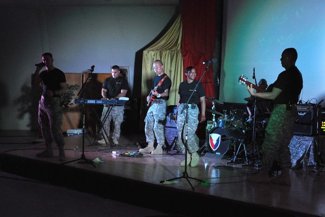 The Army Materiel Command Band, Raw Material, rocks the Morale, Welfare and Recreation theater Oct. 17 at Contingency Operating Location Q-West, Iraq. The band performed popular and classic rock songs for the Soldiers in attendance. 
(U.S. Army photo...