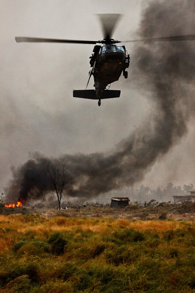 CAMP TAJI, Iraq-A UH-60 Black Hawk helicopter from 3rd Battalion, 1st Air Cavalry Brigade, 1st Cavalry Division, approaches a simulated battlefield during a joint mission between U.S. Army, Iraqi Army and Iraqi Air Force partners, Oct. 22. The...