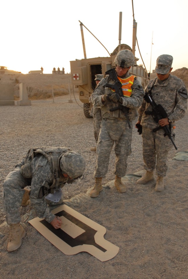 Sgt. Randall Williams, a Round Rock, Texas, native and a convoy commander with 15th Brigade Support Battalion, 2nd Brigade Combat Team, 1st Cavalry Division, waits patiently as his target is graded after a marksmanship event that was part of the...