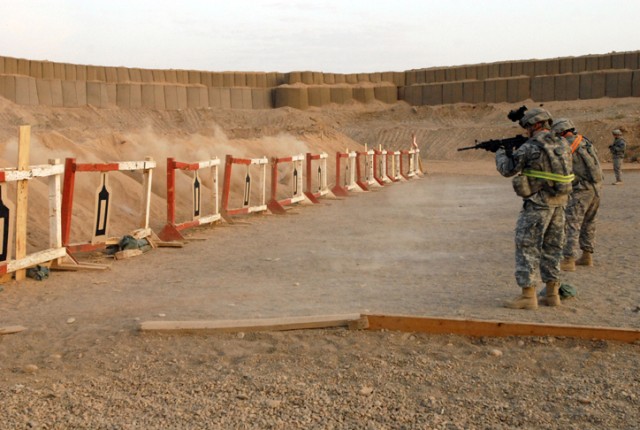 Non-commissioned officers and junior Soldiers fire their weapons during a marksmanship event that was part of both the NCO and Soldier of the Quarter competitions held on Forward Operating Base Warrior, Kirkuk, Iraq, Oct. 23. Participants were...
