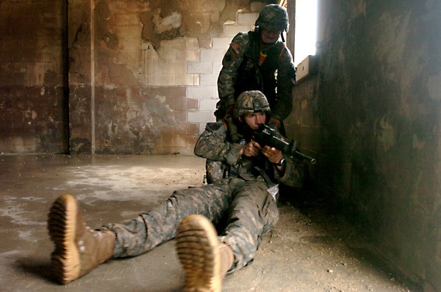 Sgt. William Farmer, a scout assigned to Troop B, 1st Squadron, 9th Cavalry Regiment, 4th BCT, 1st Cav. Div., of Killeen, Texas, watches out for enemy activity even after he is notionally shot in the leg during the Spur Ride's Scout's skills...