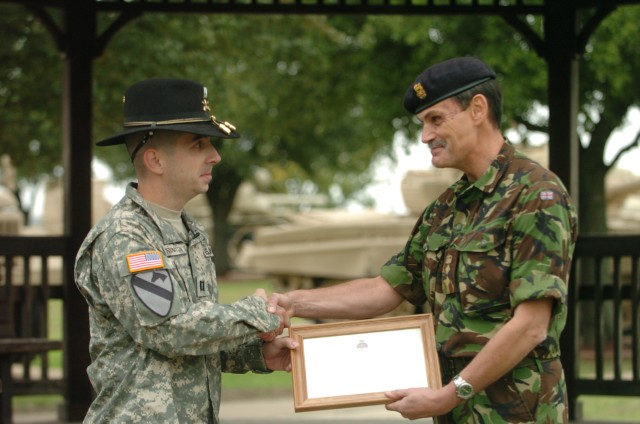 British Col. John Rouse (right), Assistant Military Attaché to the British Defense Staff in Washington, D.C., presents Capt. Brent Harrington a Joint Commander's Commendation from the British Army at the 1st Cavalry Division Museum Oct. 28 at...